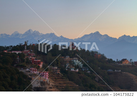View of the Himalayas at sunrise from Nagarkot, a village on the outskirts of Kathmandu, Nepal in South Asia View of the Himalayas at sunrise from Nagarkot, a village on the outskirts of Kathmandu, Nepal in South Asia 104173822