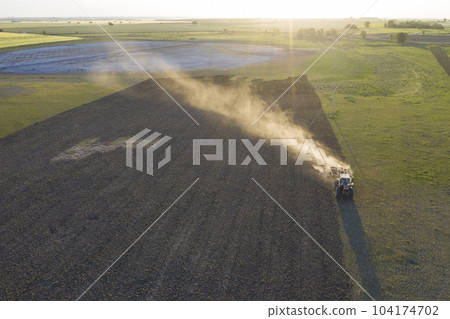 Tractor plowing the field, Pampas countryside, La Pampa, Argentina. 104174702