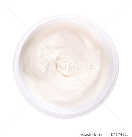 Cream yogurt, in a plastic cup. Stirred yoghurt, also spelled yogourt or yoghourt, with ten percent fat content. Dairy product, made by bacterial fermentation of mostly cow milk with yogurt cultures. 104174972