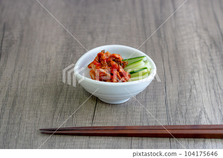 Kimchi and shredded cucumber served on a small white plate 104175646