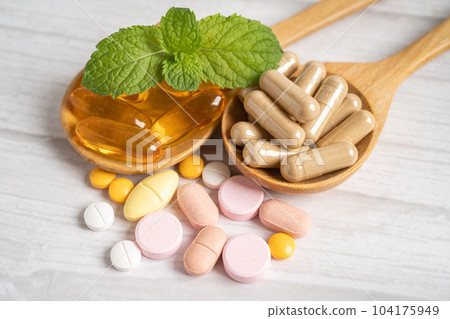 Alternative medicine herbal organic capsule with vitamin E omega 3 fish oil, mineral, drug with herbs leaf natural supplements for healthy good life. 104175949