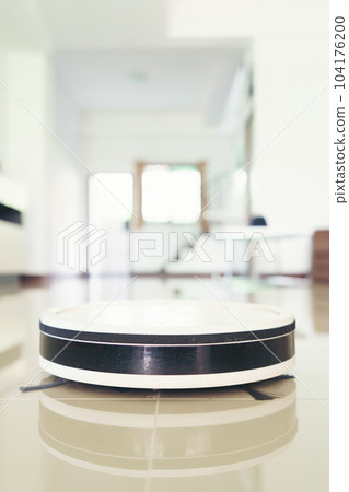 vacuum cleaning robot cleaning the room. vacuum cleaning robot cleaning the room. 104176200