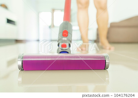 clean floor with a vacuum cleaner at home 104176204