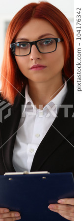 Portrait of businesswoman in glasses in business suit with clipboard Portrait of businesswoman in glasses in business suit with clipboard 104176342