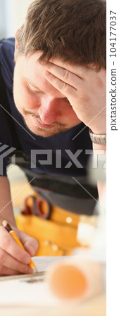 Pensive architect builder engineer thinks over blueprint Pensive architect builder engineer thinks over blueprint 104177037