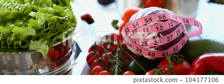 Fresh juicy vegetables with measuring tape closeup Fresh juicy vegetables with measuring tape closeup 104177106