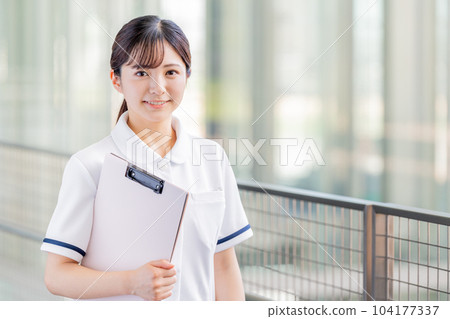 Nurses walking down hospital aisles 104177337
