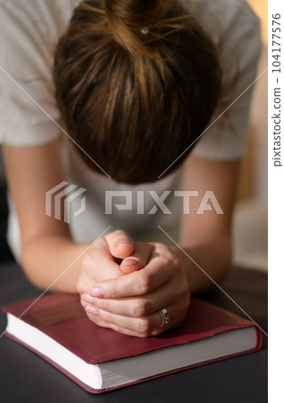 Christian Woman Hands Folded On Holy Bible Are Pray And Worship Christian Woman Hands Folded On Holy Bible Are Pray And Worship 104177576