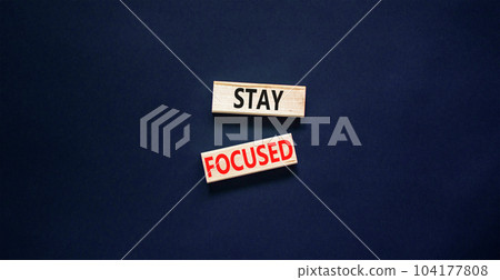 Stay focused symbol. Concept words Stay focused on wooden blocks on a beautiful black table black background. Business, support, motivation, psychological and stay focused concept. Copy space. Stay focused symbol. Concept words Stay focused on wooden blocks on a beautiful black table black background. Business, support, motivation, psychological and stay focused concept. Copy space. 104177808
