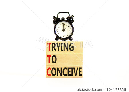 TTC trying to conceive symbol. Concept words TTC trying to conceive on wooden blocks on beautiful white table white background. Black alarm clock. Medical TTC trying to conceive concept. Copy space. TTC trying to conceive symbol. Concept words TTC trying to conceive on wooden blocks on beautiful white table white background. Black alarm clock. Medical TTC trying to conceive concept. Copy space. 104177836