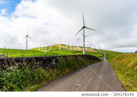 Panoramic view of wind farm or wind park, with high wind turbines for generation electricity with copy space. Panoramic view of wind farm or wind park, with high wind turbines for generation electricity with copy space. 104178148