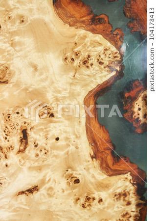 Wooden table covered with epoxy resin. Top view of a tree as a background with space to copy. High quality photo 104178413