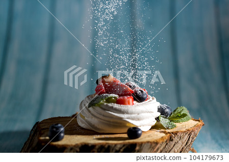 Powdered sugar decorates Pavlova's dessert Powdered sugar decorates Pavlova's dessert 104179673