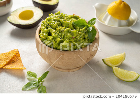 Guacamole avocado mash dip, with tortilla chips and fresh avocados Guacamole avocado mash dip, with tortilla chips and fresh avocados 104180579