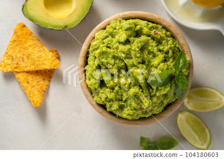 Guacamole avocado mash dip, with tortilla chips. Top view Guacamole avocado mash dip, with tortilla chips. Top view 104180603