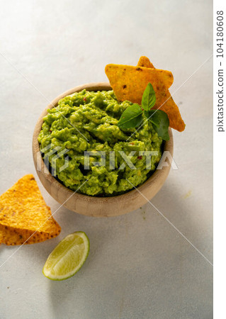Guacamole avocado mash dip, with tortilla chips and fresh avocados Guacamole avocado mash dip, with tortilla chips and fresh avocados 104180608
