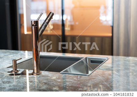 A modern faucet and sink in a trendy kitchen 104181832