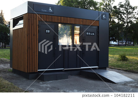 Modern bio-toilet modular toilet in the park. Mobile eco-friendly on the street with standard cabins and a cabin for people with disabilities in a wheelchair Modern bio-toilet modular toilet in the park. Mobile eco-friendly on the street with standard cabins and a cabin for people with disabilities in a wheelchair 104182211