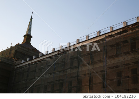Abandoned building under renovation. An old windowless building with a yellow facade and scaffolding for workers. Exterior of an old shabby building Abandoned building under renovation. An old windowless building with a yellow facade and scaffolding for workers. Exterior of an old shabby building 104182230