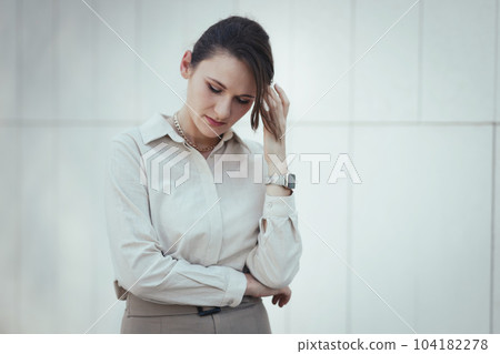 Caucasian woman in office or business style in clothes feels tired and depressed, burnout at work 104182278