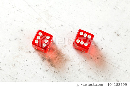 Two red craps dices showing Boxcars or Midnight (double number six) overhead shot on white board 104182599