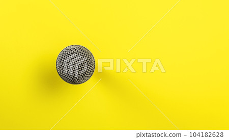 Microphone on yellow board, direct top down view, only ball with grid visible making so it looks abstract. 104182628