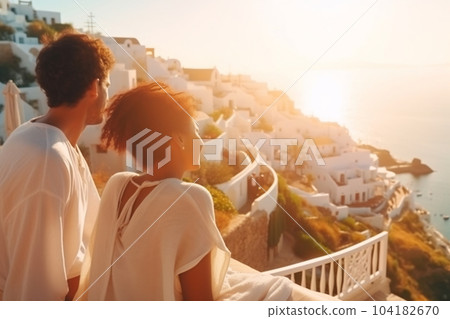 Beautiful young woman and man on their summer vacation walk on greek island Santorini 104182670