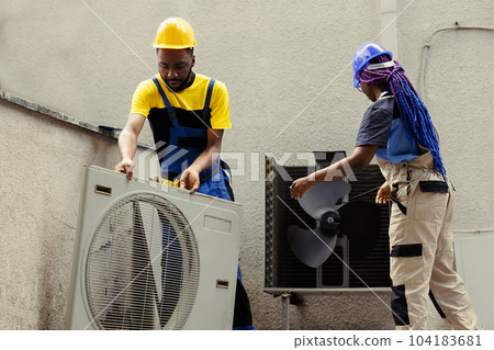 African american efficient technicians disassembling hvac system panel with industry techniques and equipment to repair air filters, refrigerant leaks and frozen evaporator coils African american efficient technicians disassembling hvac system panel with industry techniques and equipment to repair air filters, refrigerant leaks and frozen evaporator coils 104183681