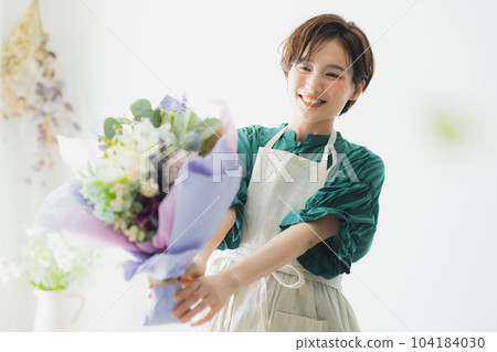 A bouquet of flowers, an apron woman 104184030