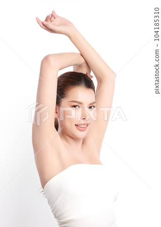 Beautiful Young Asian woman lifting hands up to show off clean and hygienic armpits or underarms on white background, Smooth armpit cleanliness and protection concept 104185310