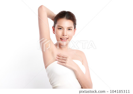 Beautiful Young Asian woman lifting hands up to show off clean and hygienic armpits or underarms on white background, Smooth armpit cleanliness and protection concept 104185311