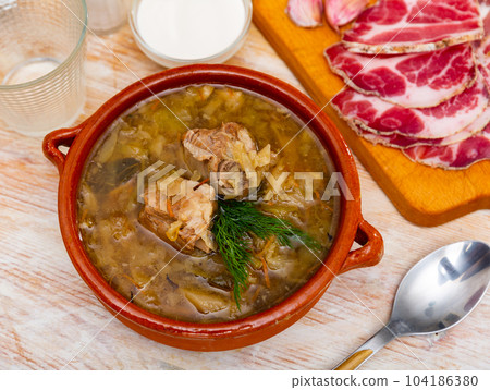 Traditional Russian dish is cabbage soup 104186380