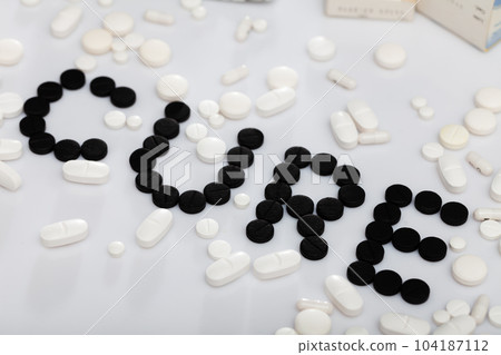 Word CURE made of pills 104187112