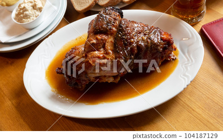 Fried pork knuckle (boar knee) with mustard and horseradish. Traditional czech dish 104187129