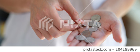 Georgian one lari coins in woman hand closeup 104189969