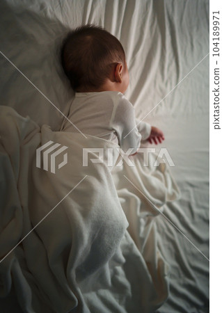 infant baby sleeping on bed at night infant baby sleeping on bed at night 104189971