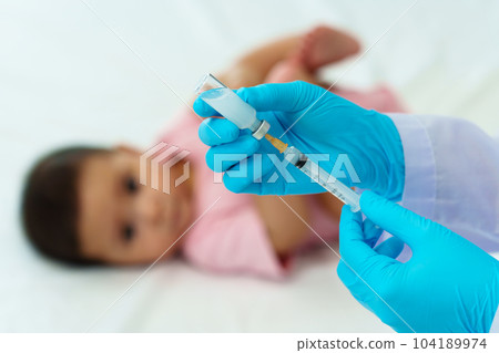 doctor drawing syringe and preparing vaccine giving injection to baby doctor drawing syringe and preparing vaccine giving injection to baby 104189974