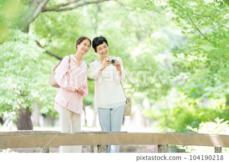 middle-aged woman travel camera 104190218