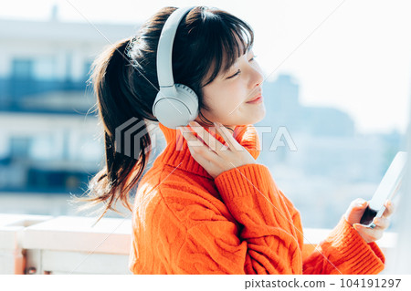 A young woman operating a smartphone A young woman operating a smartphone 104191297
