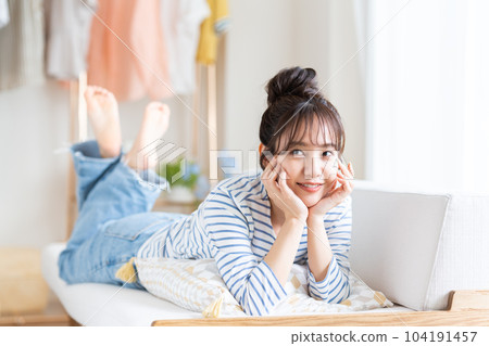 Young woman relaxing in the living room Young woman relaxing in the living room 104191457
