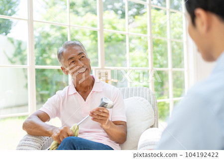 Senior man relaxing in the living room 104192422