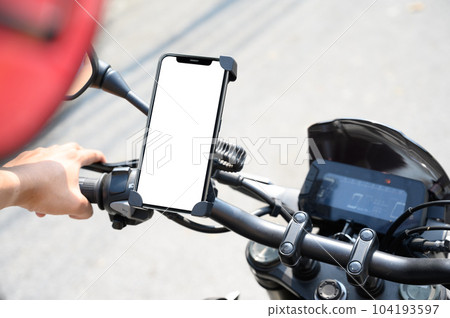 smart phone mount on motorcycle mock up, riding a motorcycle with smartphone map navigation concept, blank phone screen template on white background with clipping path 104193597