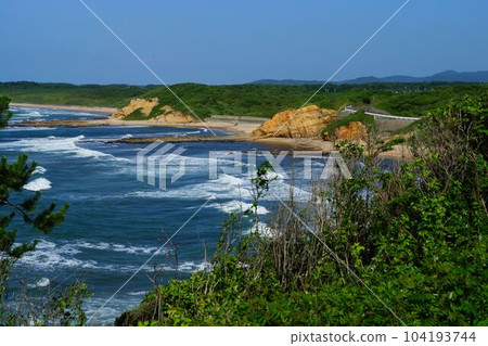 White waves crashing on the beach in summer 104193744