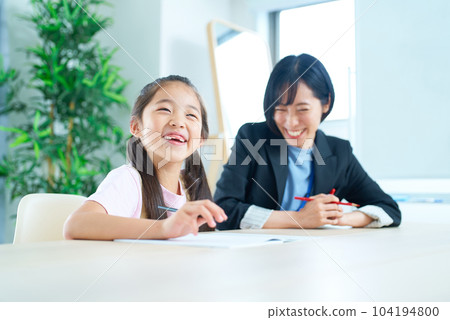 A girl studying and a woman in a suit to support 104194800