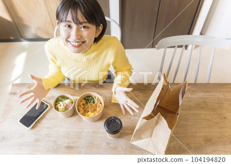 Young woman ordering food delivery 104194820