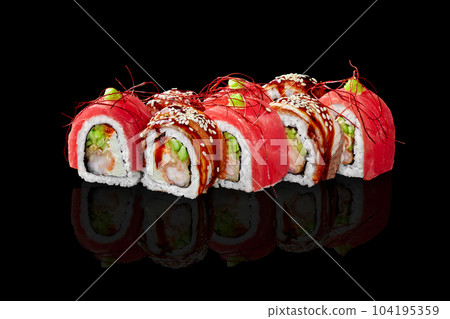 Uramaki with shrimp, cucumber and cream cheese wrapped in eel and tuna 104195359