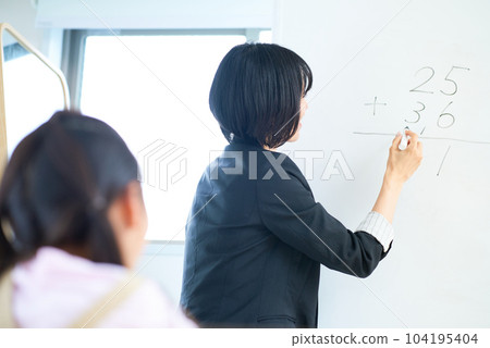 A woman in a suit teaching a child 104195404