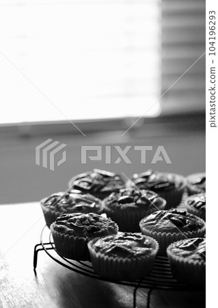 Homemade white chocolate muffins with lots of nuts, monochrome photo 104196293