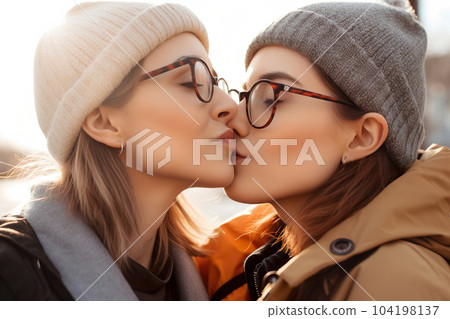 Two young women spending time together, kissing. LGBT, lesbian couple, relationship. Diversity, homosexuality. Partners with non-traditional sexual orientation. Sensual moment. Generative AI. Two young women spending time together, kissing. LGBT, lesbian couple, relationship. Diversity, homosexuality. Partners with non-traditional sexual orientation. Sensual moment. Generative AI. 104198137
