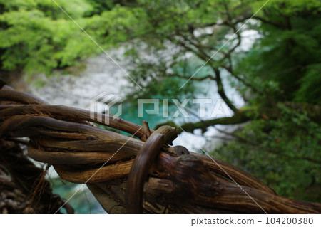 A part of the handrail of Iya Kazura Bridge and the Iya River flowing below A part of the handrail of Iya Kazura Bridge and the Iya River flowing below 104200380